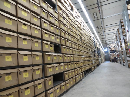 The wall of boxes on the main aisle of the State Records Center. Each of those boxes is considered 1 cubic foot. And they are stacked 2 deep on the shelves!