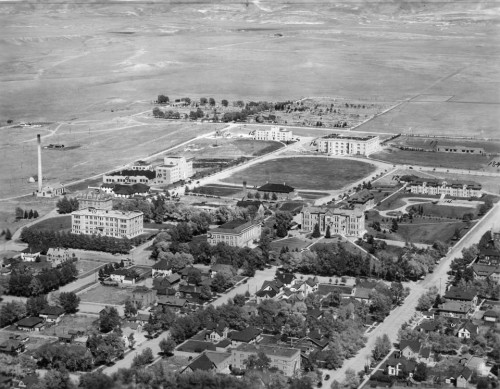 Aerial view of the University of Wyoming campus in 1931. Half Acre Gym is the large building located on the very edge of campus at the top of the shot, just to the left of the stadium and athletic fields where the student union now stands.  (WSA BCR state government buildings survey photo album)